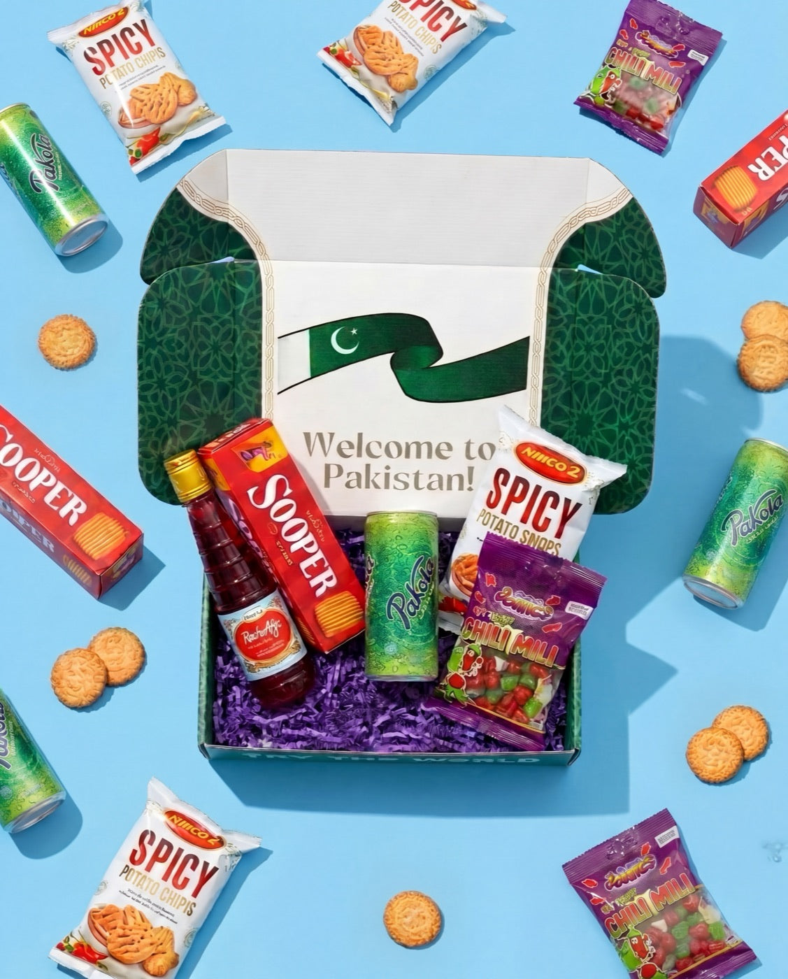 An open Root Crate reading Welcome to Pakistan, filled with Rooh Afza, Pakola, Sooper biscuits, Nimco and Chili Mili